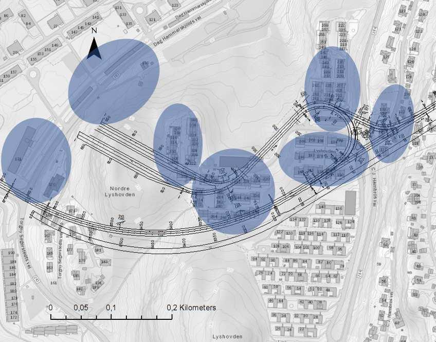 Figur 20: Bebyggelse innenfor 100 m fra sprengningsstedet for depot er markert med blå farge. Fundamenteringsforholdene har stor betydning for grenseverdiene.