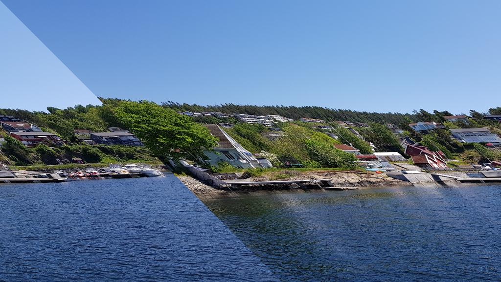 Figur 8. Bildet viser Husvikholmen 4 og 6 sett fra sjøen. Foto: Sweco Norge AS Oppsummering Området er i dag allerede utbygd med enebolig og forsamlingslokale med tilhørende hageareal.