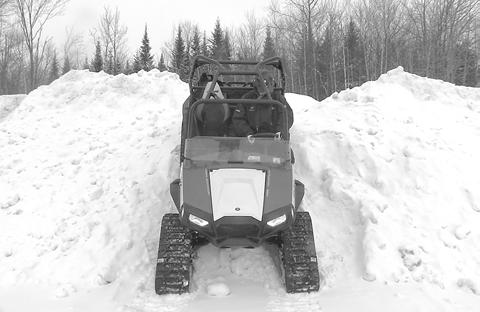 DESCENDING AND BEING STUCK IN REVERSE CAUTION: If the rear Track Systems get stuck in the snow, avoid moving or towing the vehicle in reverse to ease it from its position, as