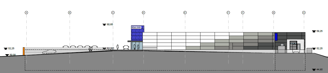 Høydeforskjellen mellom veien opp til butikken og gang- og sykkelveien er bygget opp med en mur som vil vende mot boligene i sør.