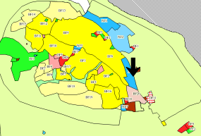 (i kommuneplan fra senest 1988) Gjeldende forhold: Forretninger, boliger, næring, skog Foreslått formål: Sentrumsformål eller kombinasjon av bolig/næring.