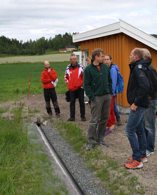 Figur 11. Målerenne for oppsamling av overflateavrenning, laget av et delt PVC-rør. Jorda inn mot renna er beskyttet av nettingduk og gras. 3.