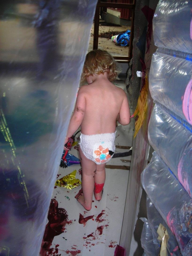 The girl explores the floor with foots and wall