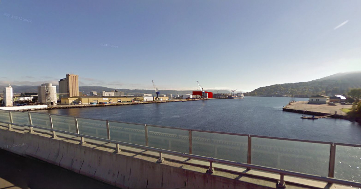 Fotomontasjen viser planområdet med bygg (rødt) fra motorveibroen, (Google maps.) 5.