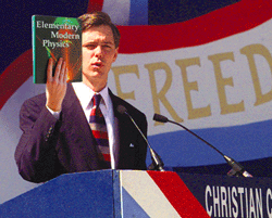 Kansas Capitol Ralph Reed holds a textbook he claims is being used to teach physics