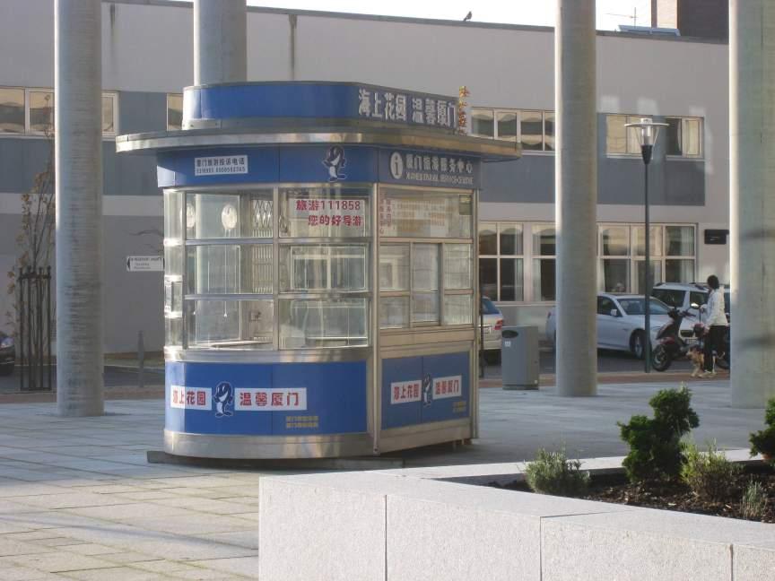 Vågen videregående skole Kunstprosjektet her består av fem deler: - en aviskiosk produsert i Kina er plassert utenfor hovedinngangen - en kinesisk gatelykt plassert foran endeveggen - busstopp