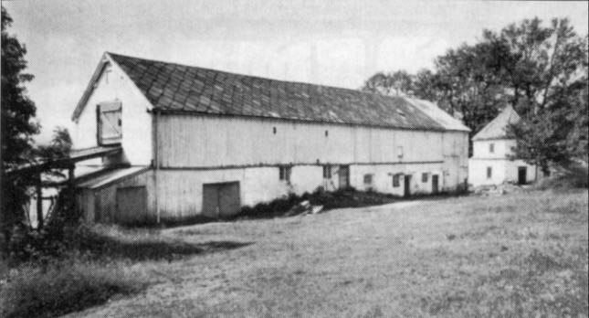 Løa fotografert av T. Teigen ca. 1950. bordklædt og malet, Taget Tækket med Bord og Skiffersteen. Bygningen har i det hele 1 dobbelt og 6 enkelte Dørre, men intet Ildsted.