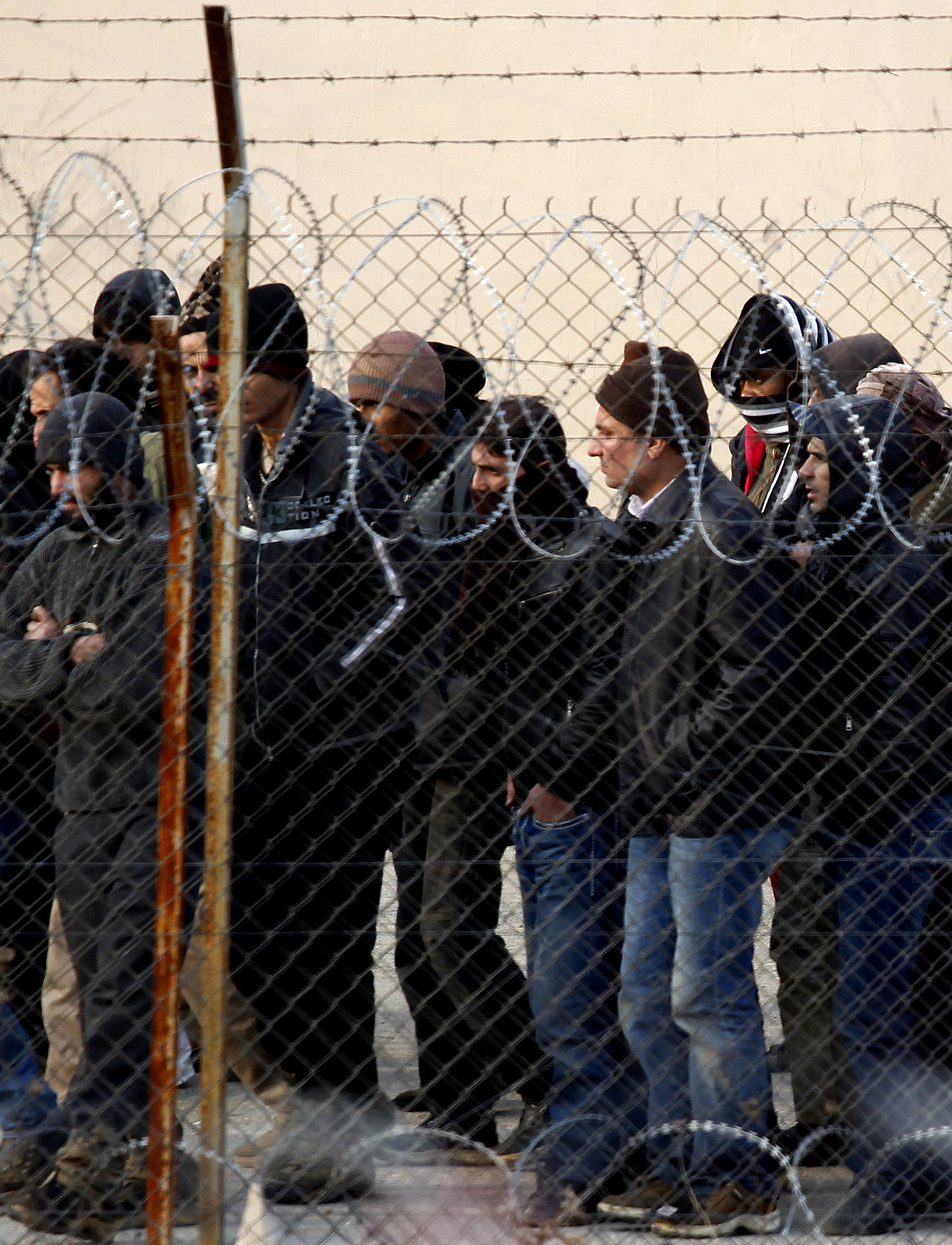 HELLAS: Asylsøkere stimler sammen utenfor gjerdet til en interneringsleir i Fylakio, nær grensen til Tyrkia idesember 2011.