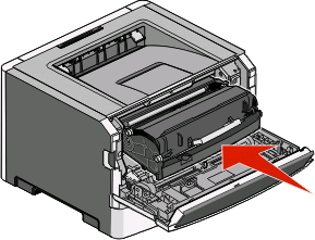 5 Sett inn tonerkassetten i fotoledersettet ved å sikte inn valsene på tonerkassetten etter sporene. Kassetten klikker på plass når den er riktig satt inn.