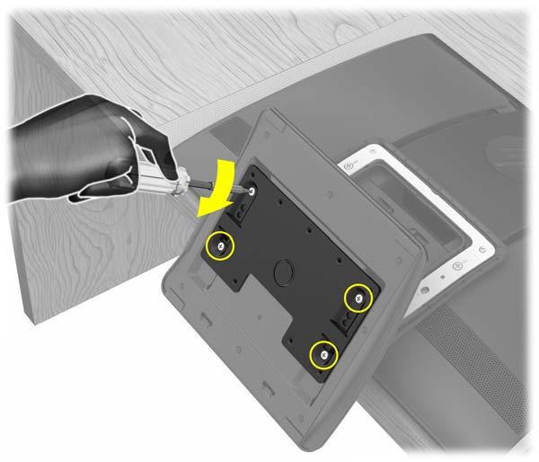 Bruk en stjerneskrutrekker til å stramme alle de fire skruene som holder VESA-adapterplaten til bunnen av datamaskinstativet.