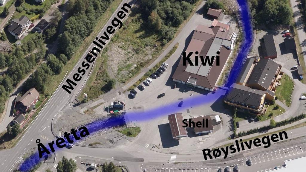Figur 1: Skråfoto, sett fra vest mot øst. Åretta er illustrert med blå strek. Sentralt i planområdet ligger dagligvareforretningen Kiwi, sørøst for krysset Messenlivegen Røyslivegen.