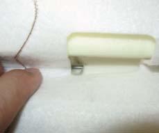 Confirm that the wire of cushion pad is seen from the hole of